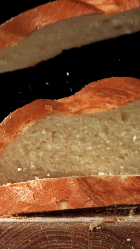 Sliced bread falls onto a cutting board. Filmed on a high-speed camera at 1000 Stock Footage 335365413