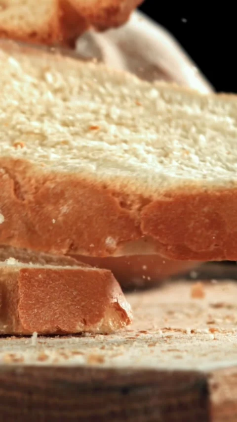 Sliced bread falls onto a cutting board. Filmed on a high-speed camera at 1000 Stock Footage 335366282