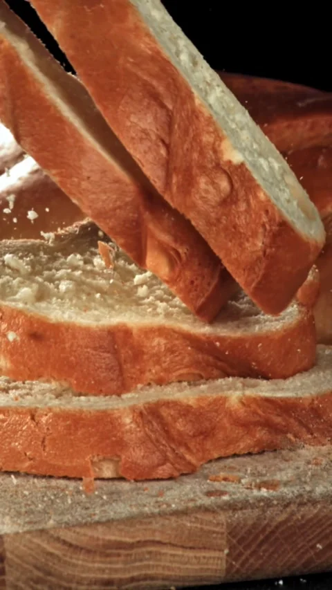 Sliced bread falls onto a cutting board. Filmed on a high-speed camera at 1000 Stock Footage 335371744