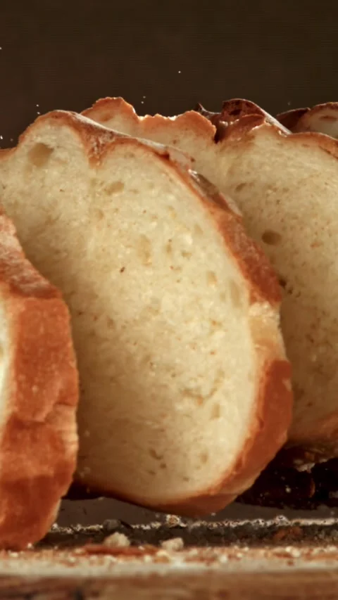 Sliced bread falls onto a cutting board. Filmed on a high-speed camera at 1000 Stock Footage 335374934