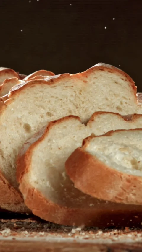 Sliced bread falls onto a cutting board. Filmed on a high-speed camera at 1000 Stock Footage 335375145