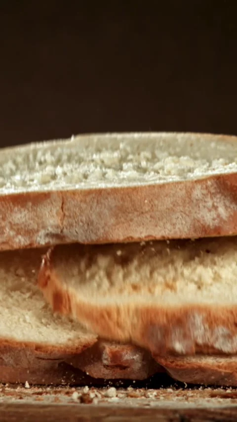 Sliced bread falls onto a cutting board. Filmed on a high-speed camera at 1000 Stock Footage 335376864