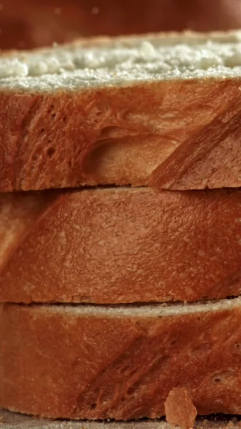 Sliced bread falls onto a cutting board. Filmed on a high-speed camera at 1000 Stock Footage 335377145