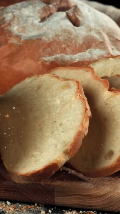 Sliced bread falls onto a cutting board. Filmed on a high-speed camera at 1000 Stock Footage 335379784