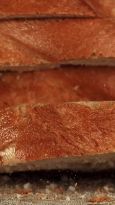 Sliced bread falls onto a cutting board. Filmed on a high-speed camera at 1000 Stock Footage 335380062
