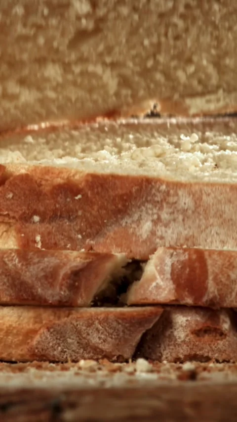 Sliced bread falls onto a cutting board. Filmed on a high-speed camera at 1000 Stock Footage 335384065