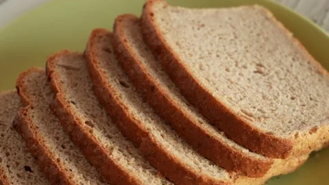 Sliced bread isolated on green plate background Stock Footage 188120035