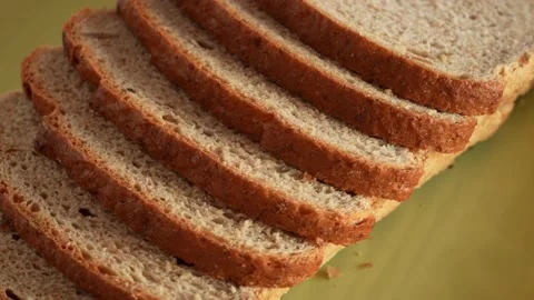 Sliced bread isolated on green plate background Stock Footage 188121310