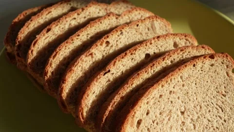 Sliced bread isolated on green plate background Stock Footage 188123607