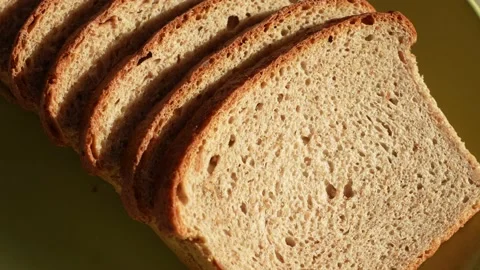 Sliced bread isolated on green plate background Stock Footage 188124536