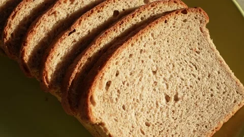 Sliced bread isolated on green plate background Stock Footage 188125461