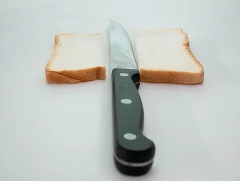 Sliced Bread with knife on white background. Stock Photos