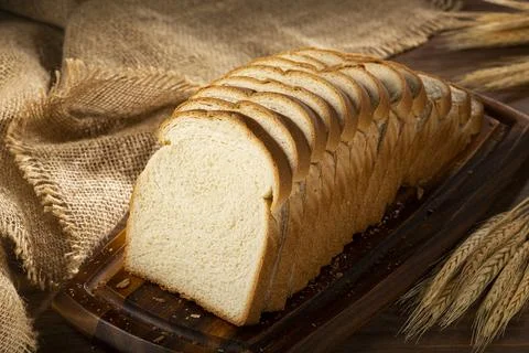 Sliced bread loaf on the table. Stock Photos