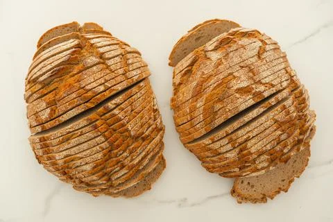 Sliced Bread Loaves on White Surface Fotos Stock