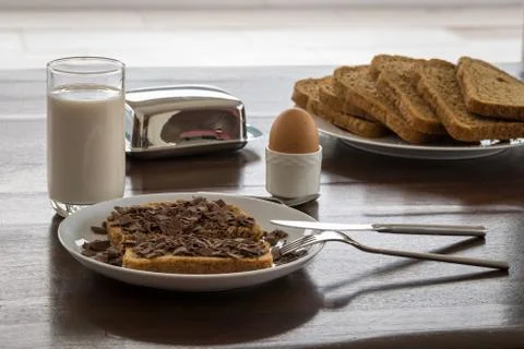 Sliced bread with milk and egg in holder Stock Photos