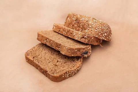 Sliced ??bread on an old paper background. Slices of bread. Side view Stock Photos