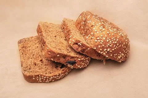 Sliced ??bread on an old paper background. Slices of bread. Side view Stock Photos