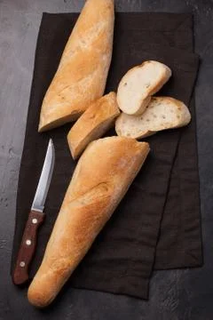 Sliced bread over dark stone table. View from above. Stock Photos