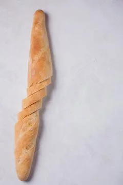 Sliced bread over light stone table. View from above with copy space Stock Photos
