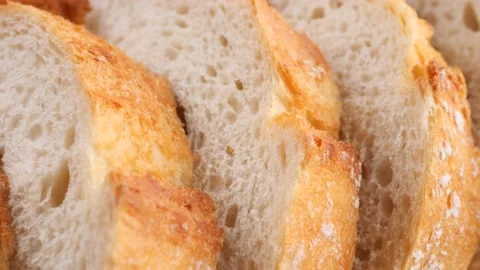 Sliced Bread slider shot. Texture of baked porous bread close-up Stock Footage 231035696