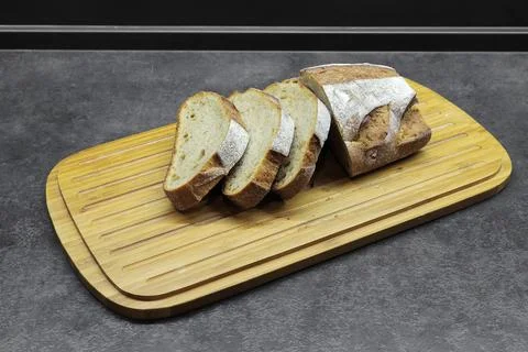 Sliced bread on a wooden plank on the table Stock Photos