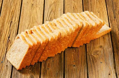 Sliced bread on wooden surface Stock Photos