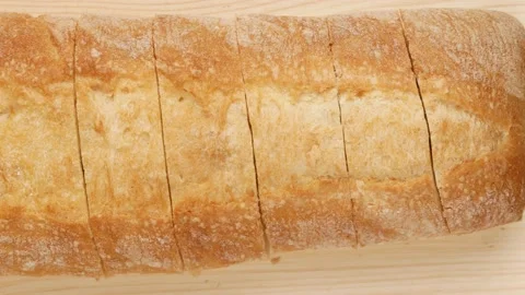 Sliced bread on a wooden table, dolly shot. Stock Footage 146273144