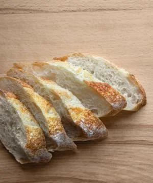 Sliced bread on a wooden table. Stock Photos