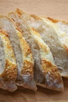 Sliced bread on a wooden table. Stock Photos