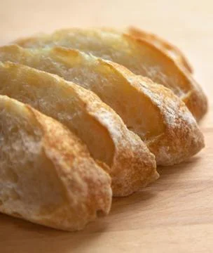Sliced bread on a wooden table. Stock Photos