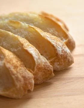 Sliced bread on a wooden table. Stock Photos