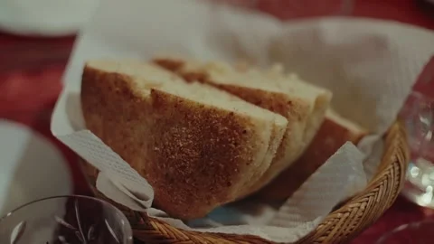 Sliced Bread in Woven Basket on Restaurant Table With Wine Glasses Stock Footage 340219912