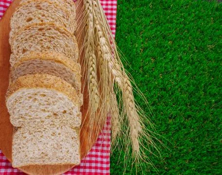 Sliced breads on grasses Stock Photos