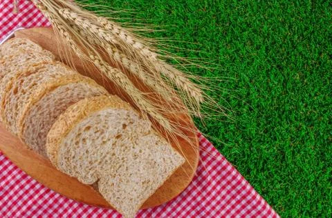 Sliced breads on grasses Stock Photos