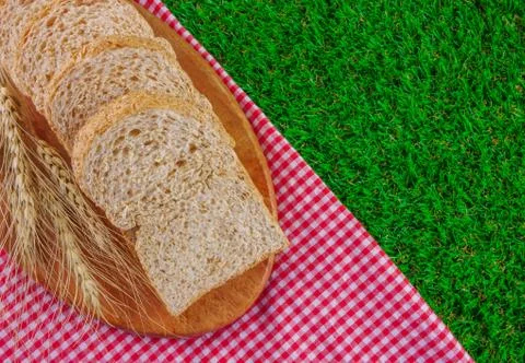 Sliced breads on grasses Stock Photos