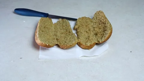 Sliced Brown Bread Roll With Knife On Counter Video stock 342850747
