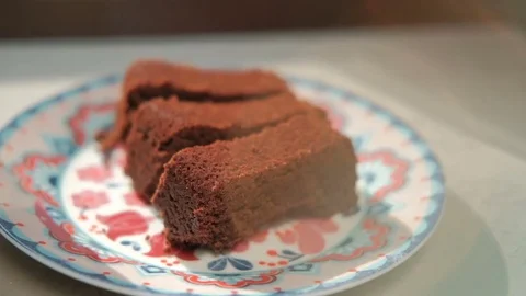 Sliced Brownie on a plate on a gray table Stock Footage 79527273