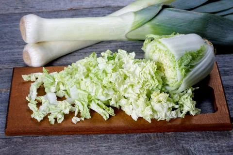 Sliced cabbage and shallots on a rustic table Stock Photos