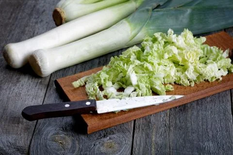 Sliced cabbage and shallots on a rustic table Stock Photos