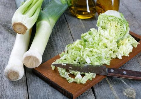 Sliced cabbage and shallots on a rustic table Stock Photos