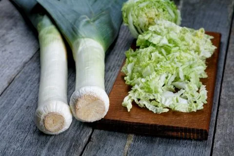 Sliced cabbage and shallots on a rustic table Stock Photos
