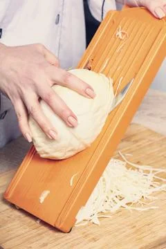 Sliced cabbage on shredder Foto stock