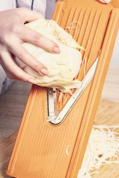Sliced cabbage on shredder Stock Photos