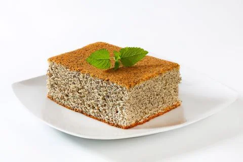 Sliced carrot cake with mint leaf garnish Stock Photos