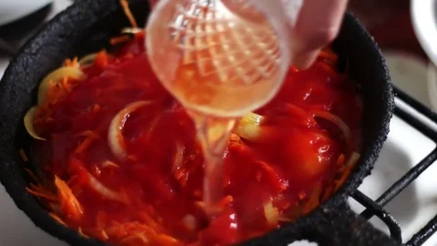 Sliced Carrots are fried in a frying pan with Tomato paste onions, vegetables Stock Footage