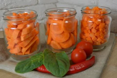 Sliced ​​carrots on a table in a jar Stock Photos