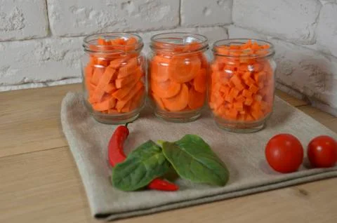 Sliced ​​carrots on a table in a jar Stock Photos