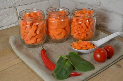 Sliced ​​carrots on a table in a jar Stock Photos