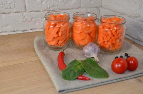 Sliced ​​carrots on a table in a jar Stock Photos