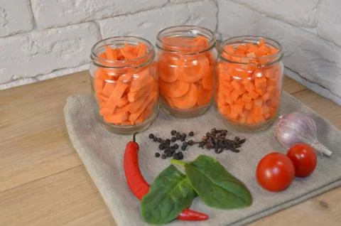 Sliced ​​carrots on a table in a jar Stock Photos